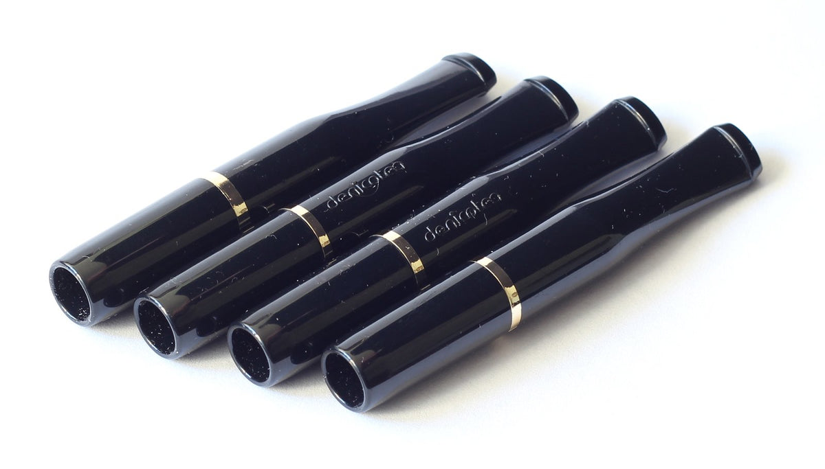 DENICOTEA cigarette holder in black with gold ring closeup showing sleek finish and elegance