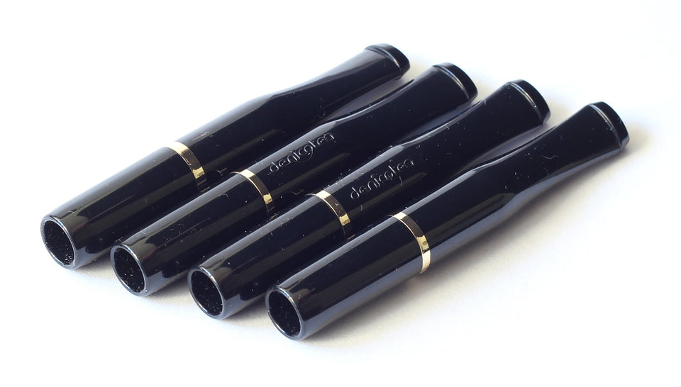 DENICOTEA cigarette holder in black with gold ring closeup showing sleek finish and elegance