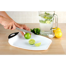 Dexas Chop and Scoop board shown with non-slip feet for stable chopping.