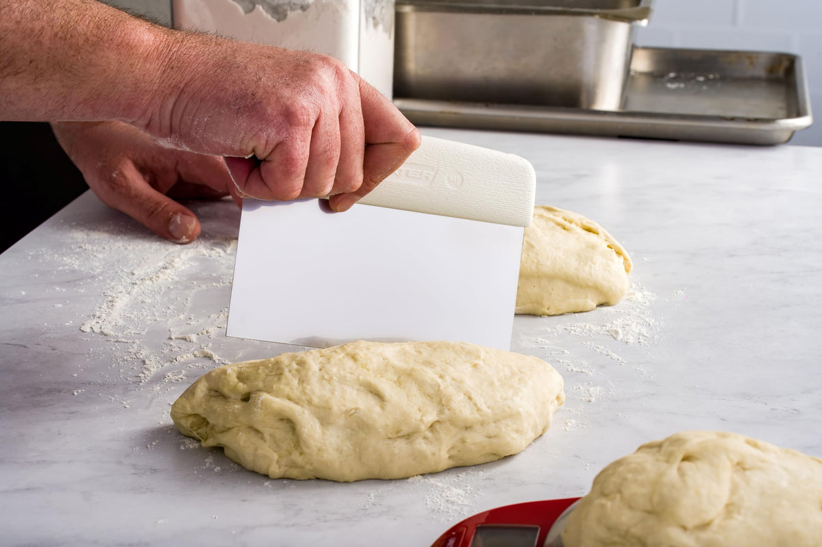 Dexter-Russell dough cutter textured handle demonstrates slip-resistant grip for steady slicing.