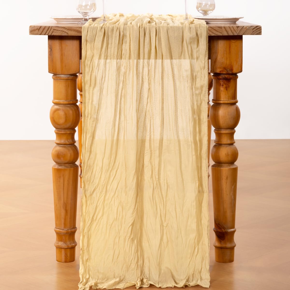 Dining table styled with DeZerlor champagne gold cheesecloth runner for bridal ambiance.