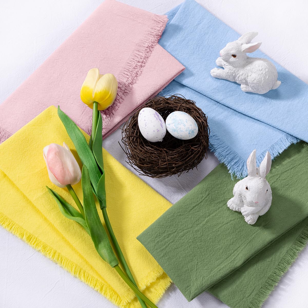 DeZerlor Easter napkins with yellow fringe on a rustic table.
