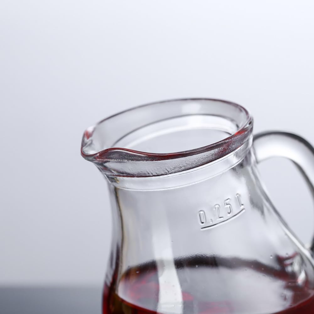 Clear hand-blown glass creamers elevate table presentation.