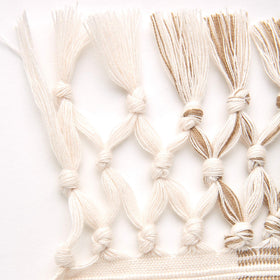 DII cotton texture close-up shows soft fabric and fringe detail