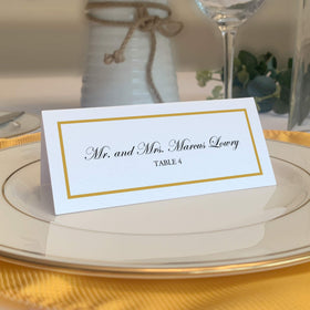 Documents and Designs gold place card front with single-line border for weddings.