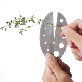 DOMG herb stripper with stainless steel handle removes kale leaves quickly and safely.