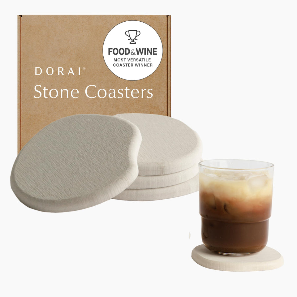 Dorai sandstone coasters on table absorb moisture to protect surfaces.