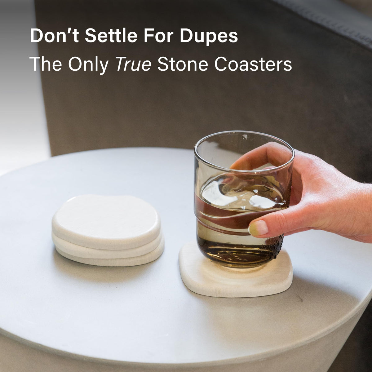 Dorai sandstone coaster beside a coffee cup protecting the table.
