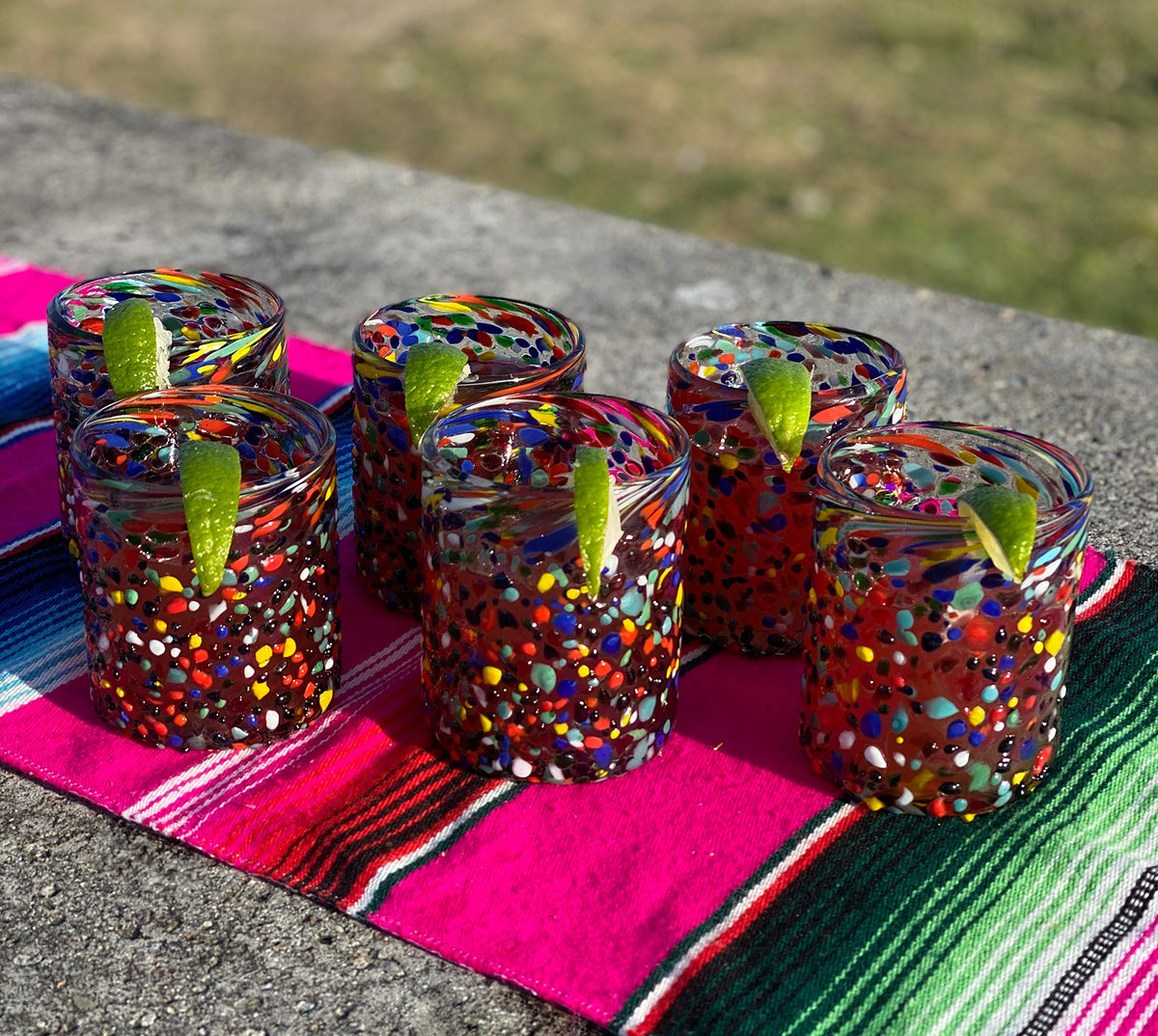 Handmade Mexican glassware by Dos Sueños with vibrant confetti design.