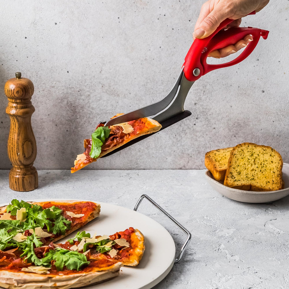 Dreamfarm Scizza stainless steel blades in action delivering clean cuts