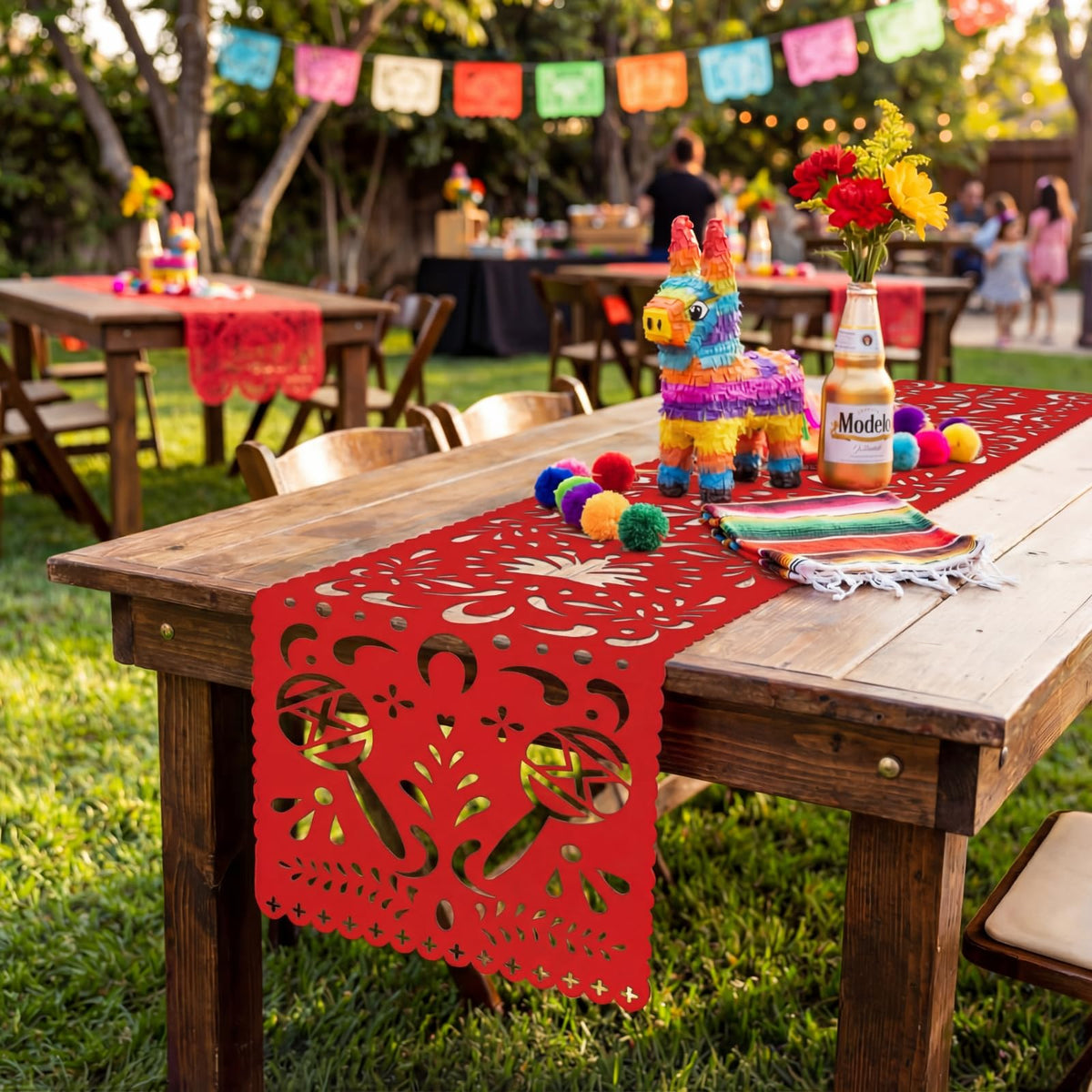 Eaasty orange papel picado table runner brightens holiday tables.