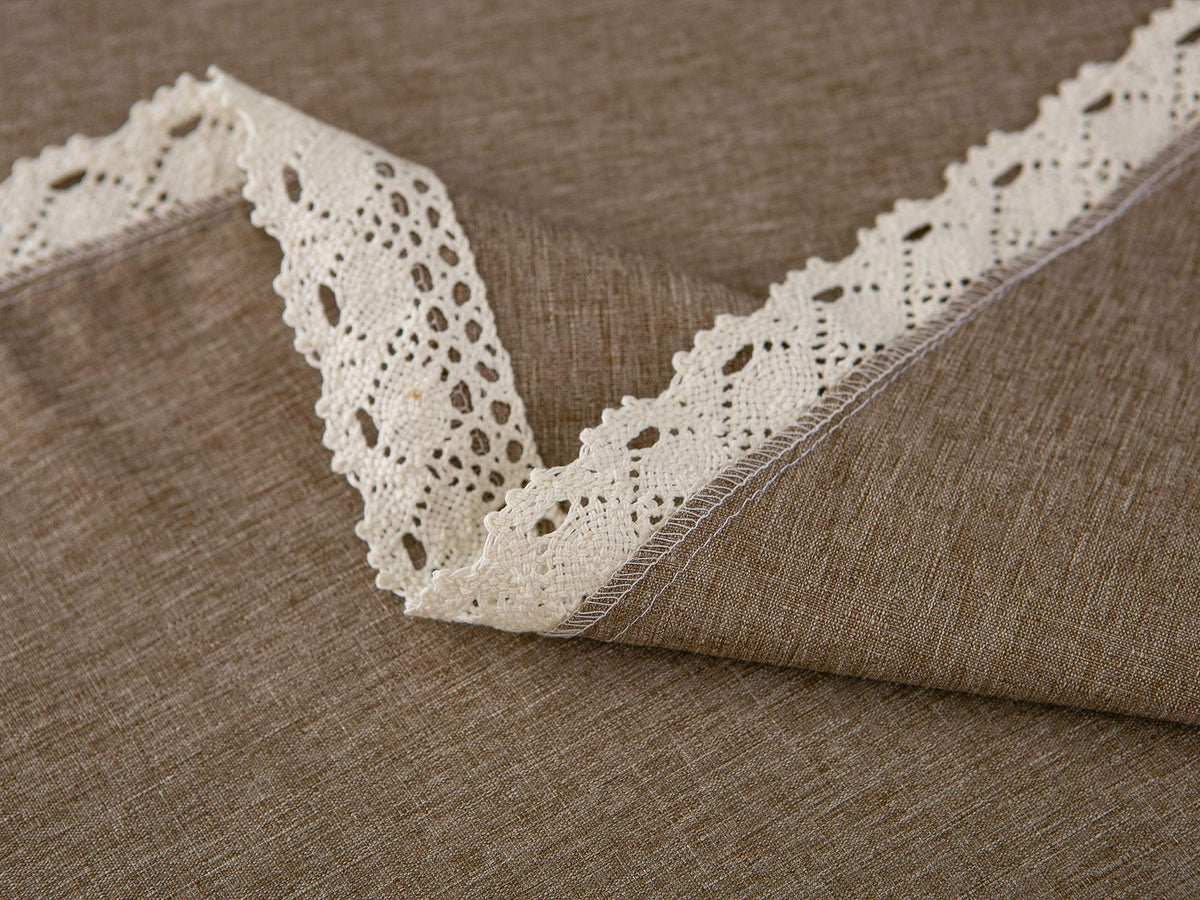 Stain-resistant tablecloth in a dining setting with lace trim detail.