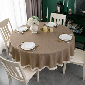Close-up of waterproof surface showing spill resistance on round tablecloth.