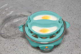 Elite Gourmet measuring cup guides water for soft, medium, or hard eggs.