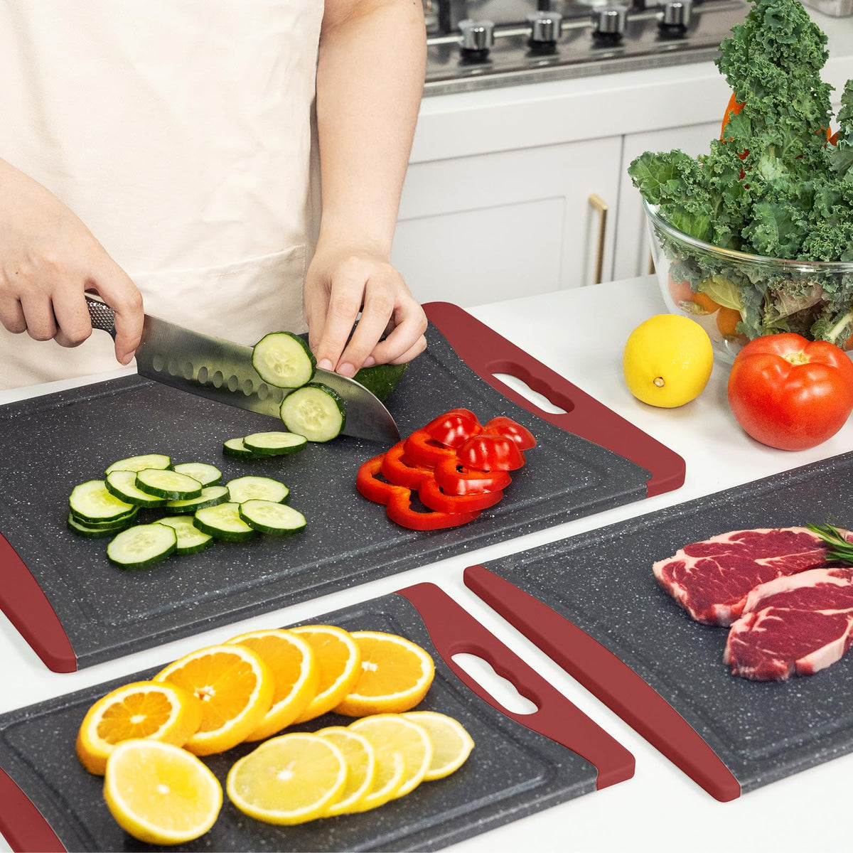 Empune red cutting boards on a kitchen counter ready to use.