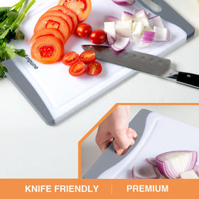 Empune grey cutting boards on the counter, juice grooves collect spills for pristine surfaces.