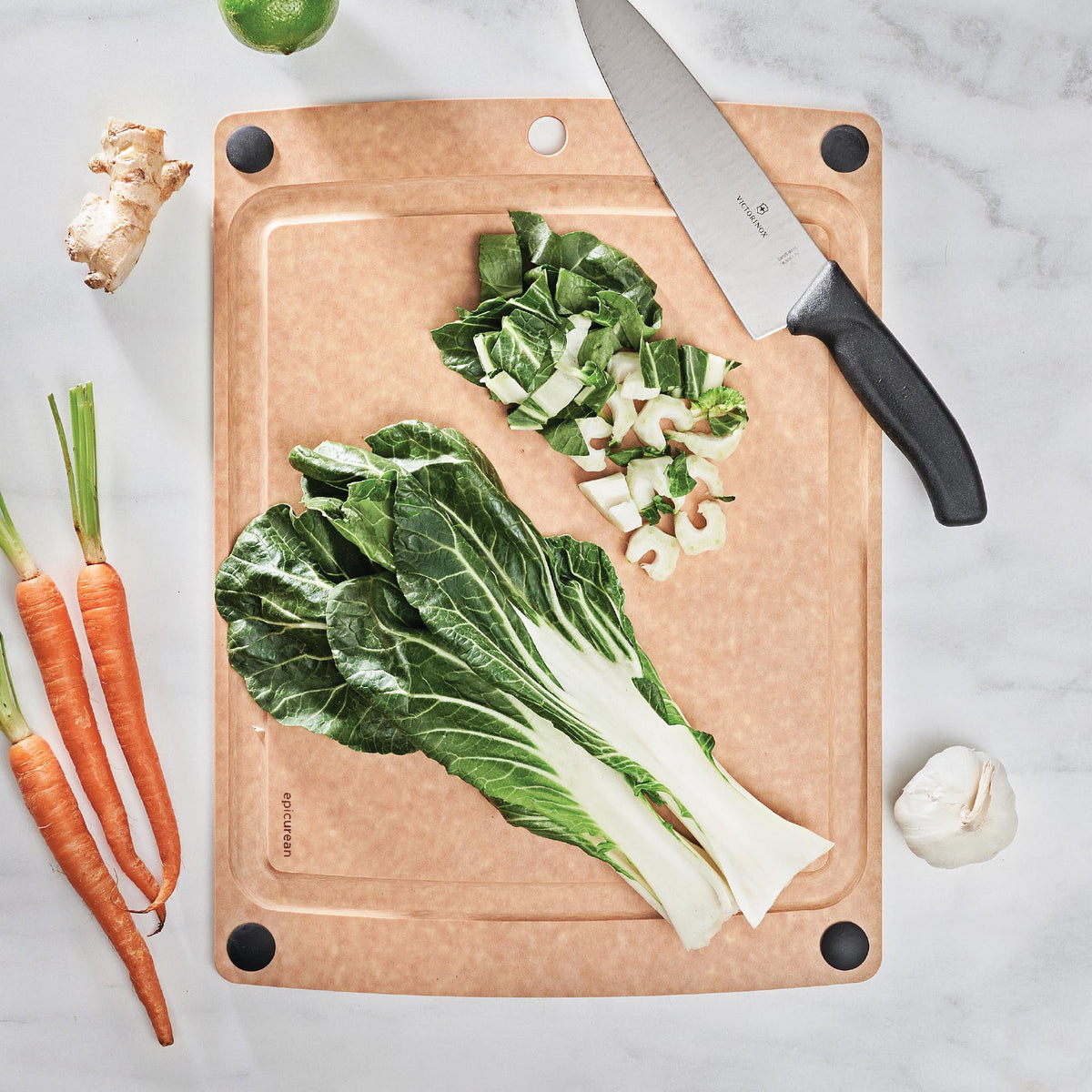Epicurean all-in-one cutting board, juice groove close-up catches juices for cleaner prep.