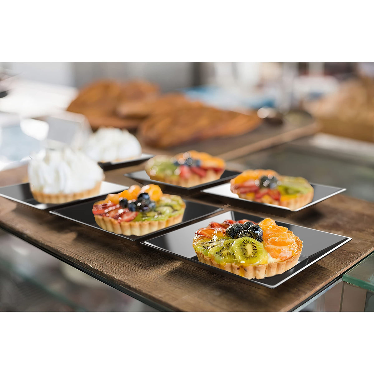 Exquisite black plates provide a sophisticated backdrop for desserts and appetizers.