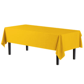 Exquisite yellow 54x108 inch rectangle tablecloth laid out for a large gathering.