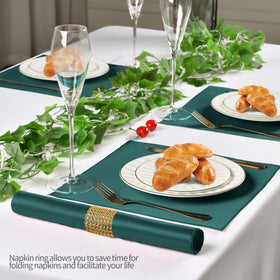 Eychei wedding banquet satin napkins with rings at a formal reception table.