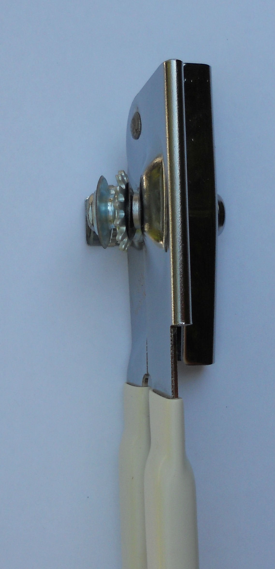 EZ-DUZ-IT can opener in use, mid-kitchen scene showing easy can opening.