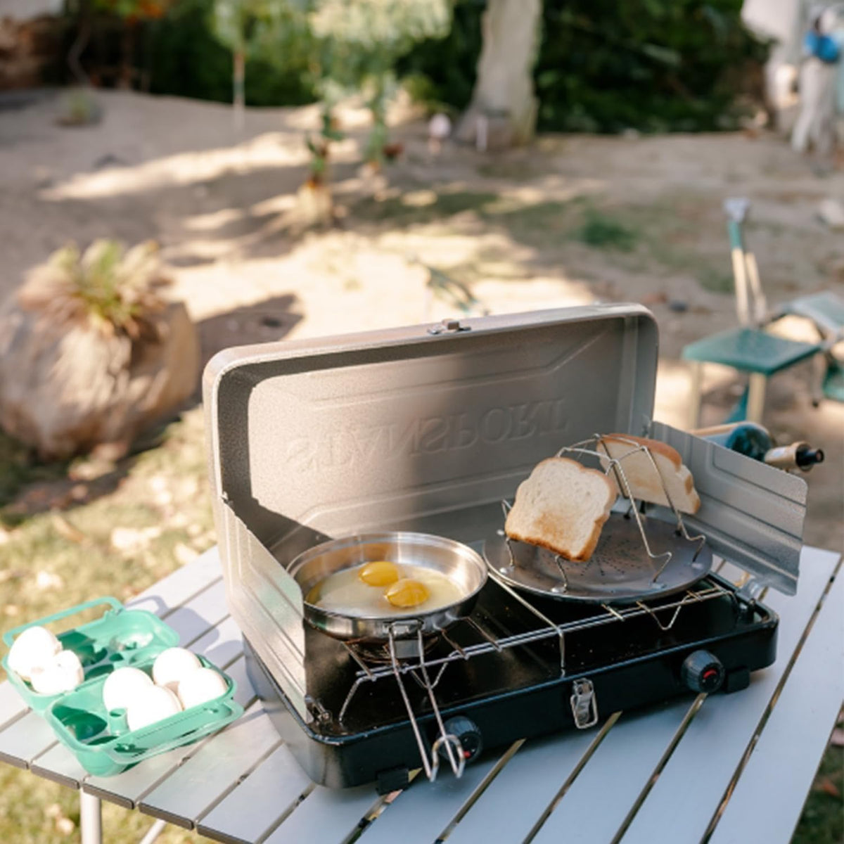 EZYoutdoor toaster toasting English muffins on a stove outdoors