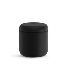 Fellow Atmos 0.7L vacuum canister with matte black finish preserves coffee freshness on the counter.