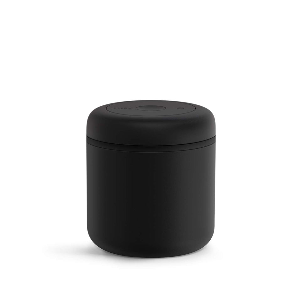 Fellow Atmos 0.7L vacuum canister with matte black finish preserves coffee freshness on the counter.