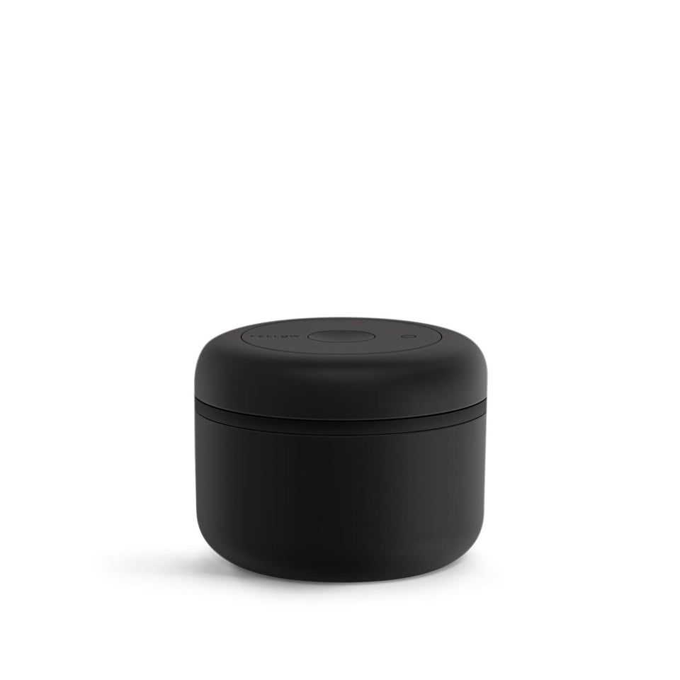 Fellow Atmos matte black canister with airtight seal preserves freshness.