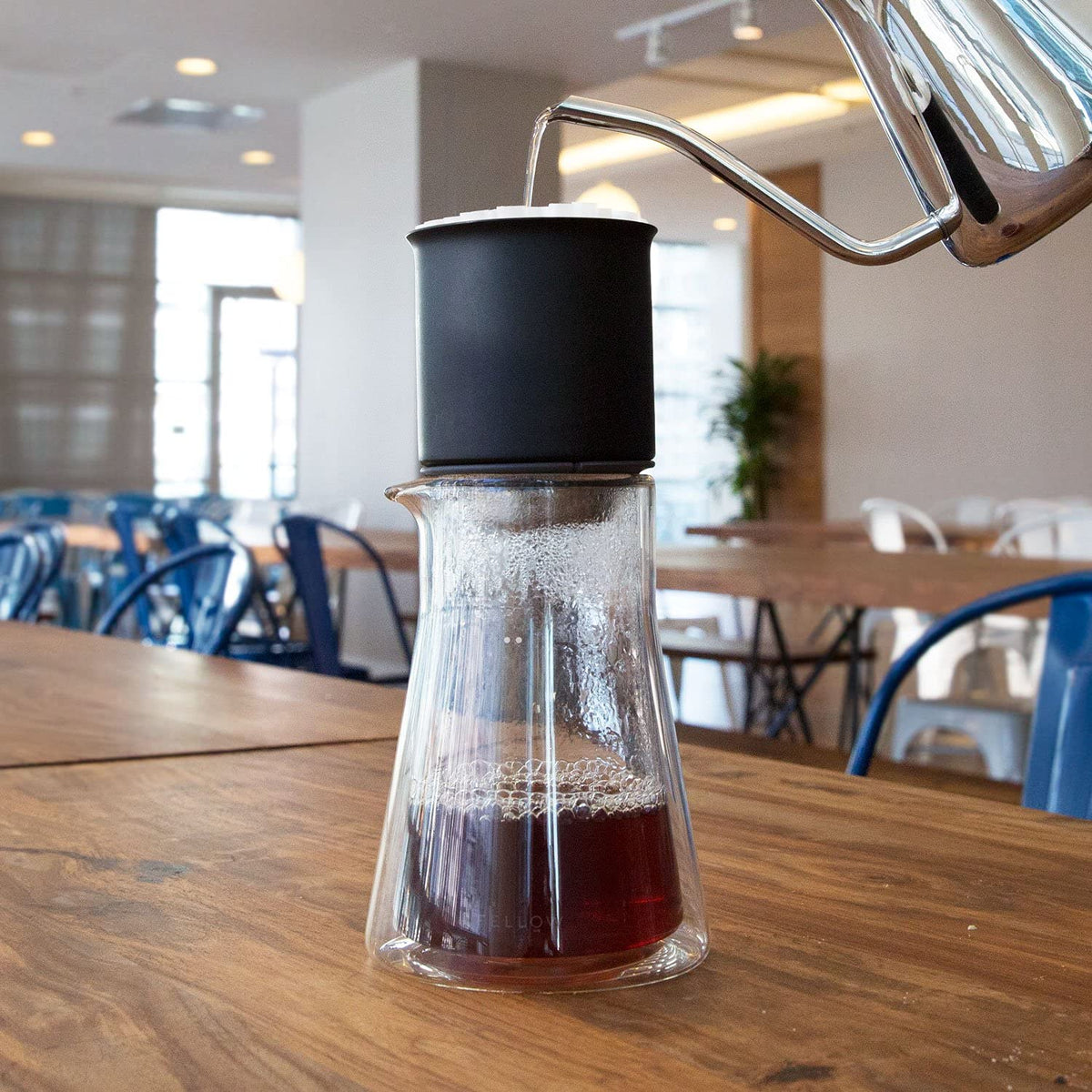 Fellow Stagg carafe on kitchen counter showcases crystal-clear contents and craft.