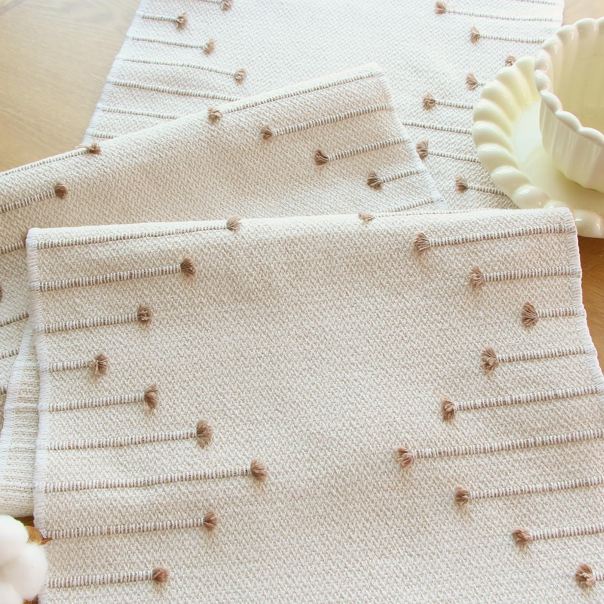 FEXIA farmhouse decor table runner close-up highlighting weave and tassels.