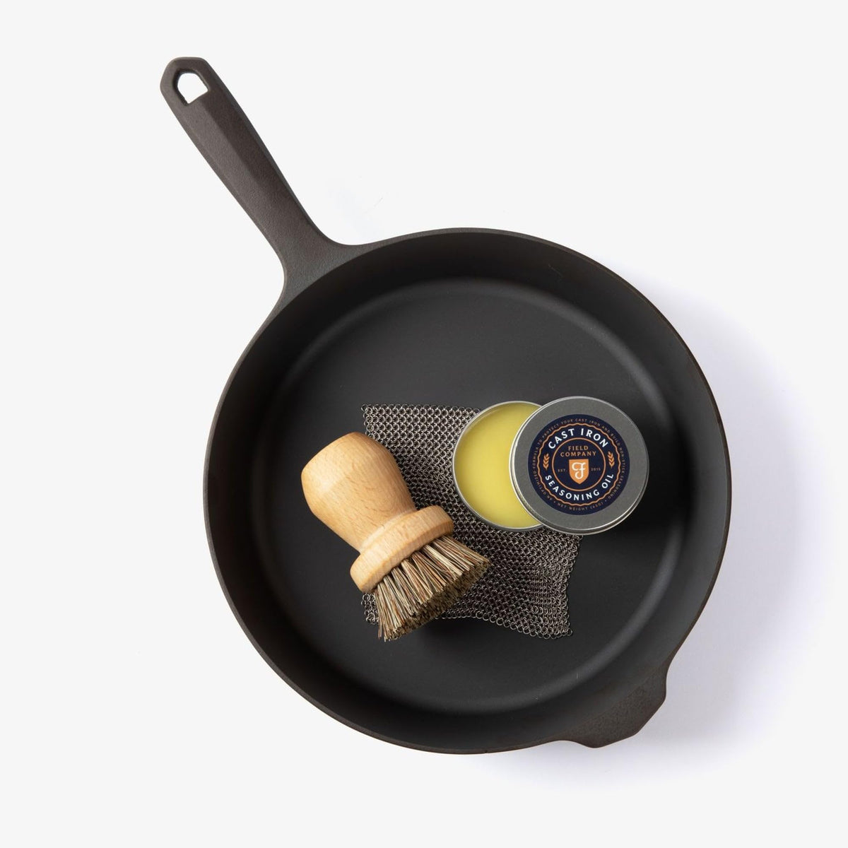 Field Company chain mail scrubber action lifts baked-on residue with care.