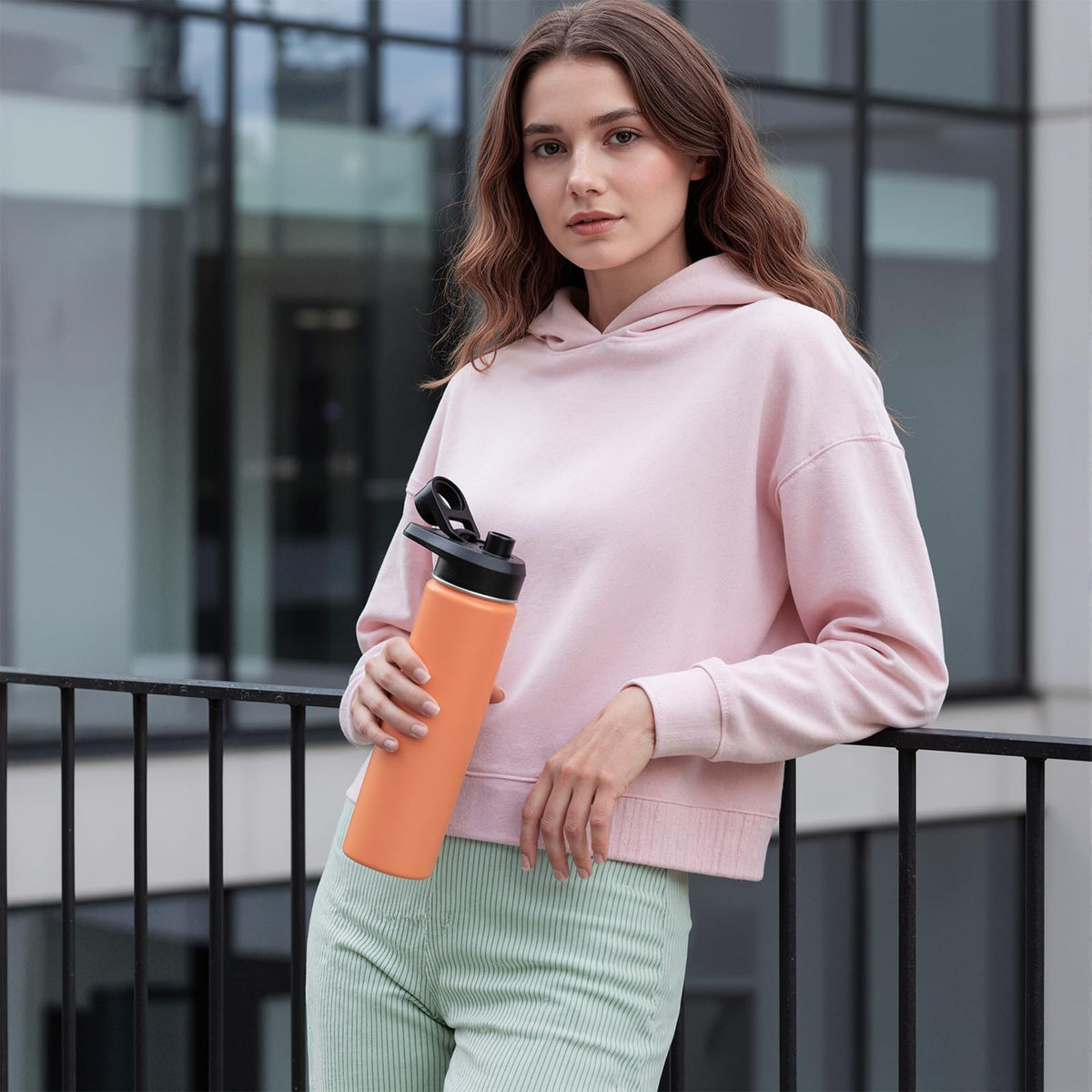 Fijinhom coral bottle in outdoor hiking scenario for hydration on the go.