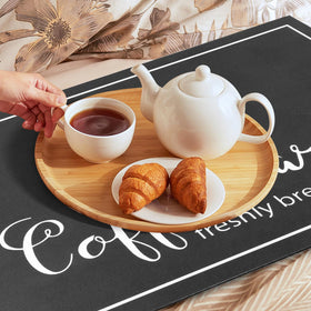Findosom absorbent mat protects floors from spills around espresso machine.