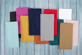 Folded FingerCraft napkin in dusty pink on plate display