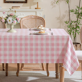 Fiokle gingham tablecloth in pink buffalo plaid on the dining table adds cozy charm for gatherings.