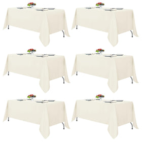 Fitable Ivory tablecloth on a 6-8 ft rectangular table for elegant dining.