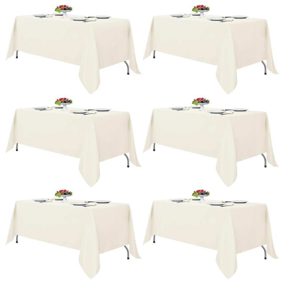 Fitable Ivory tablecloth on a 6-8 ft rectangular table for elegant dining.