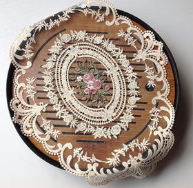 Fiygor cotton-organza embroidery on beige linens adds refined texture.