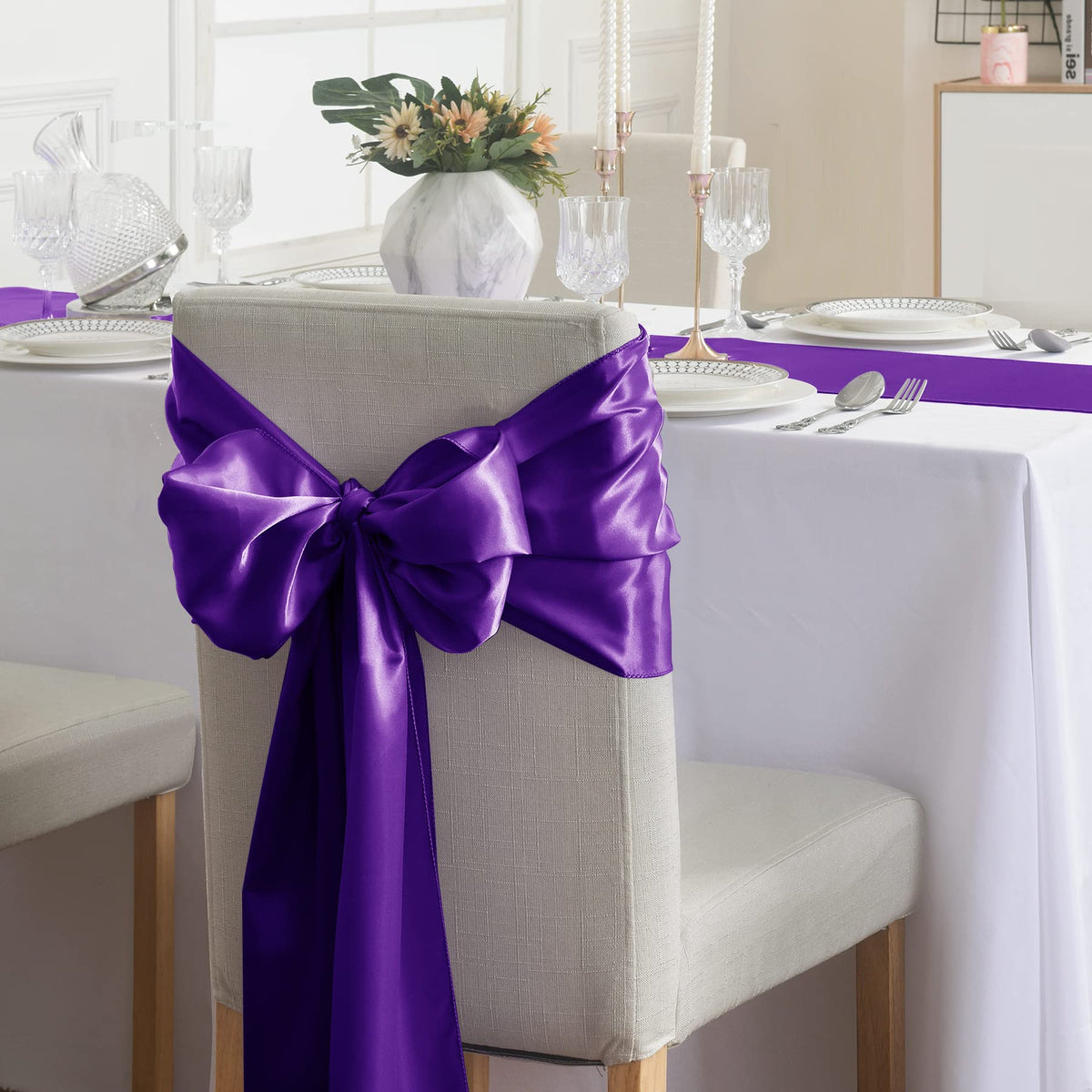 flohar silver satin table runner brings subtle shimmer to receptions.