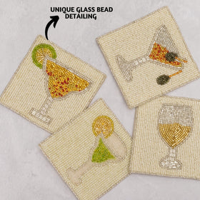 Folkulture beaded coasters showcase a center boho motif and shiny white beads for elegant tables.