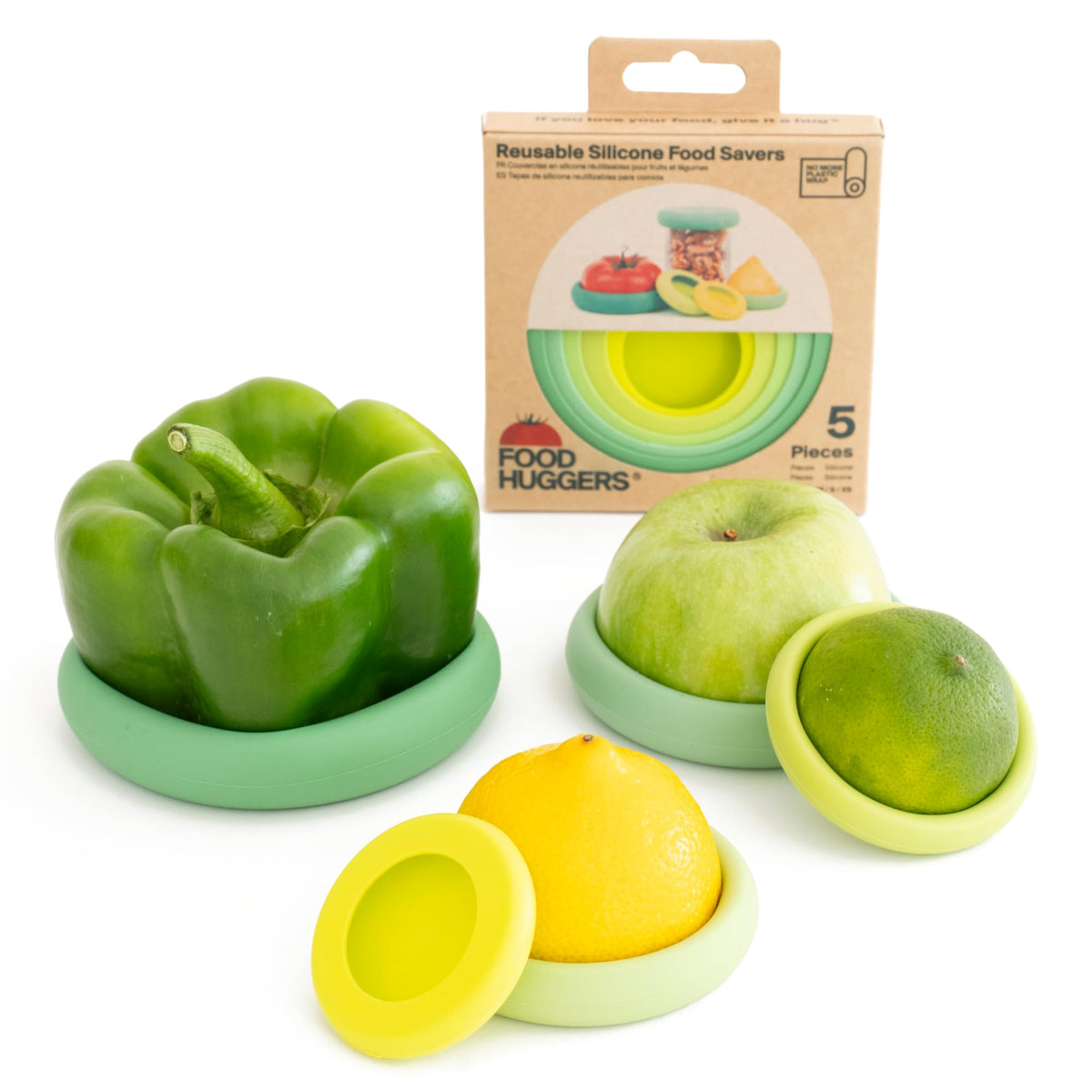 Food Huggers round sage green silicone sleeve sealing a halved fruit to stay fresh