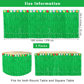 Fovths Luau grass table skirt attached around a round table with adhesive tapes.