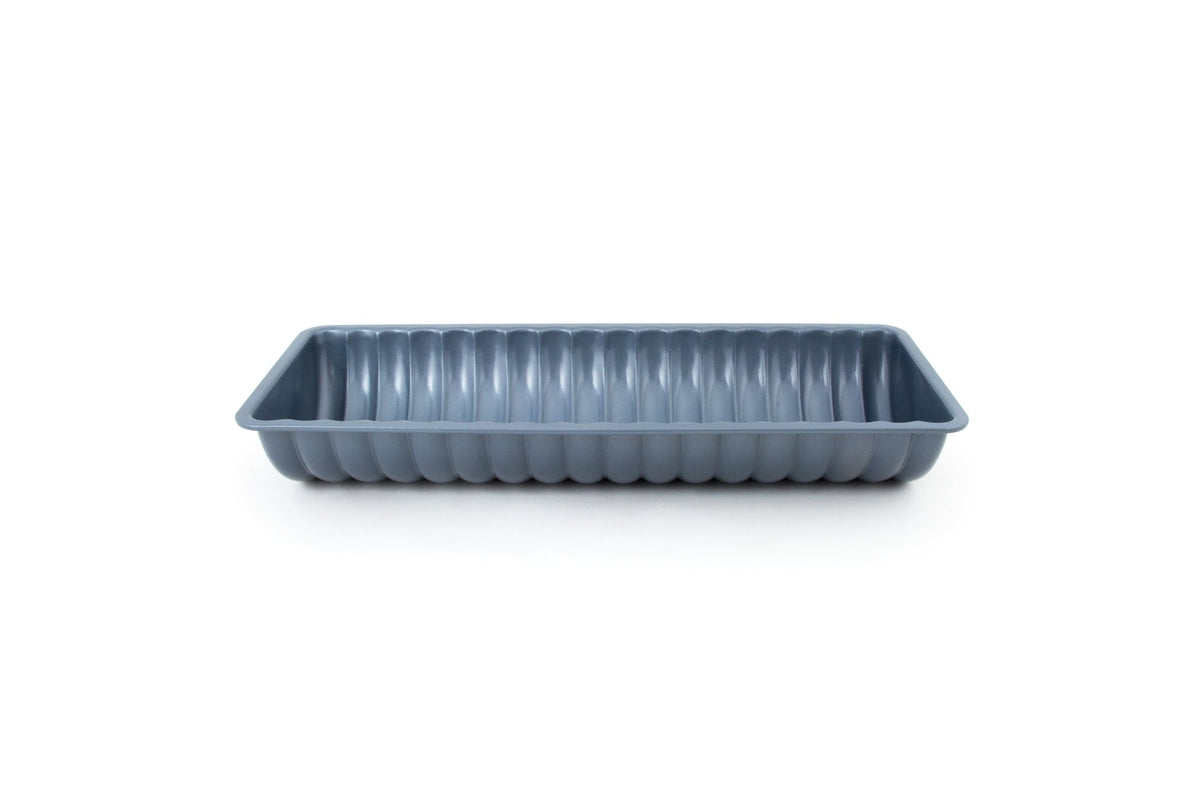Fox Run Rehrucken almond cake pan with baked cake ready for slicing.