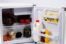 Frigidaire compact fridge in dorm or office setup.
