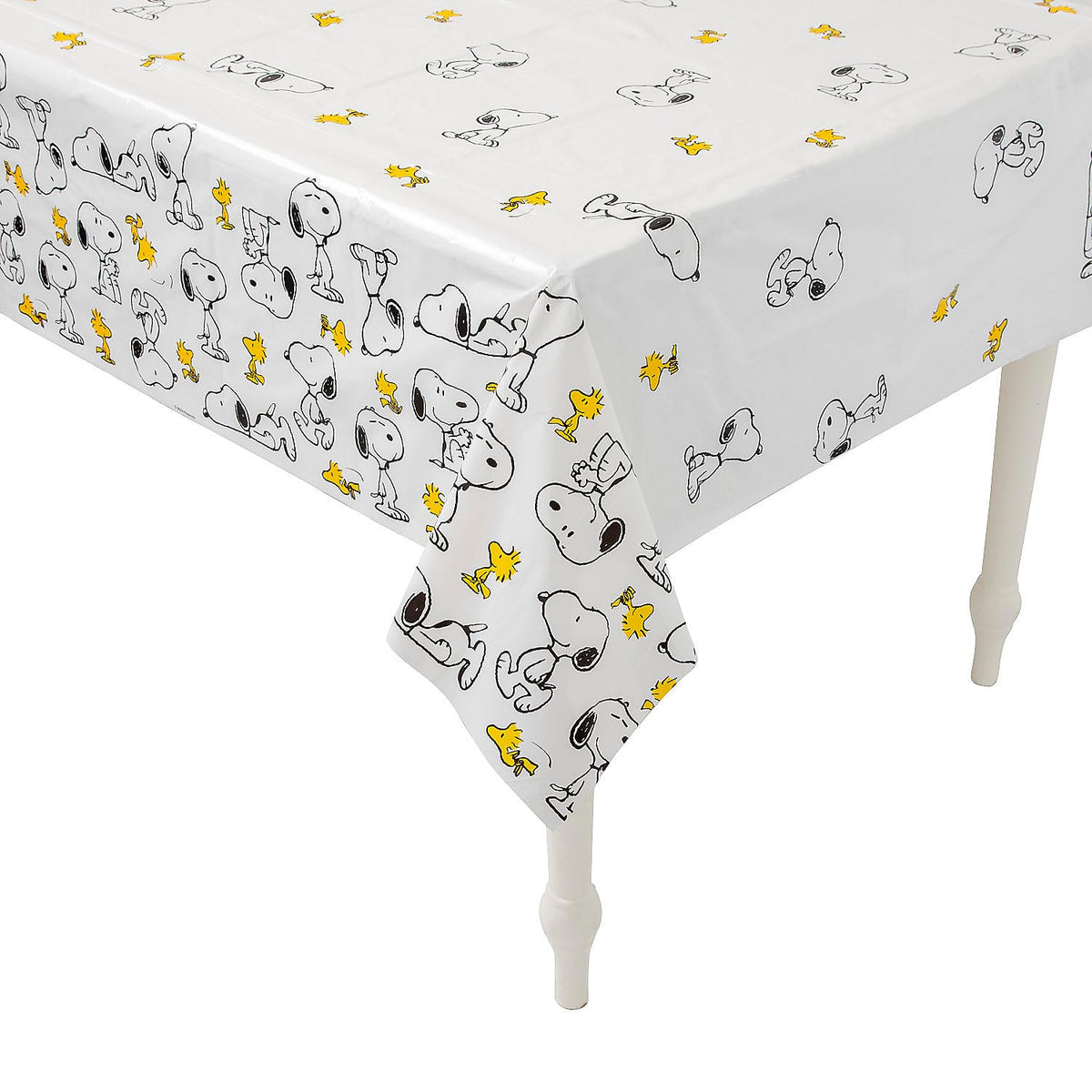 Fun Express Peanuts Snoopy Woodstock tablecloth covering a table for festive use