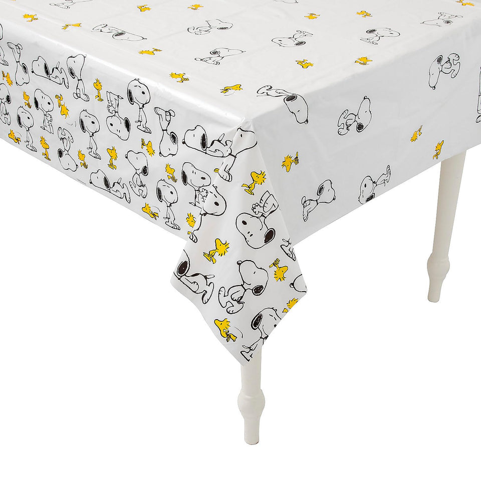 Fun Express Peanuts Snoopy Woodstock tablecloth covering a table for festive use
