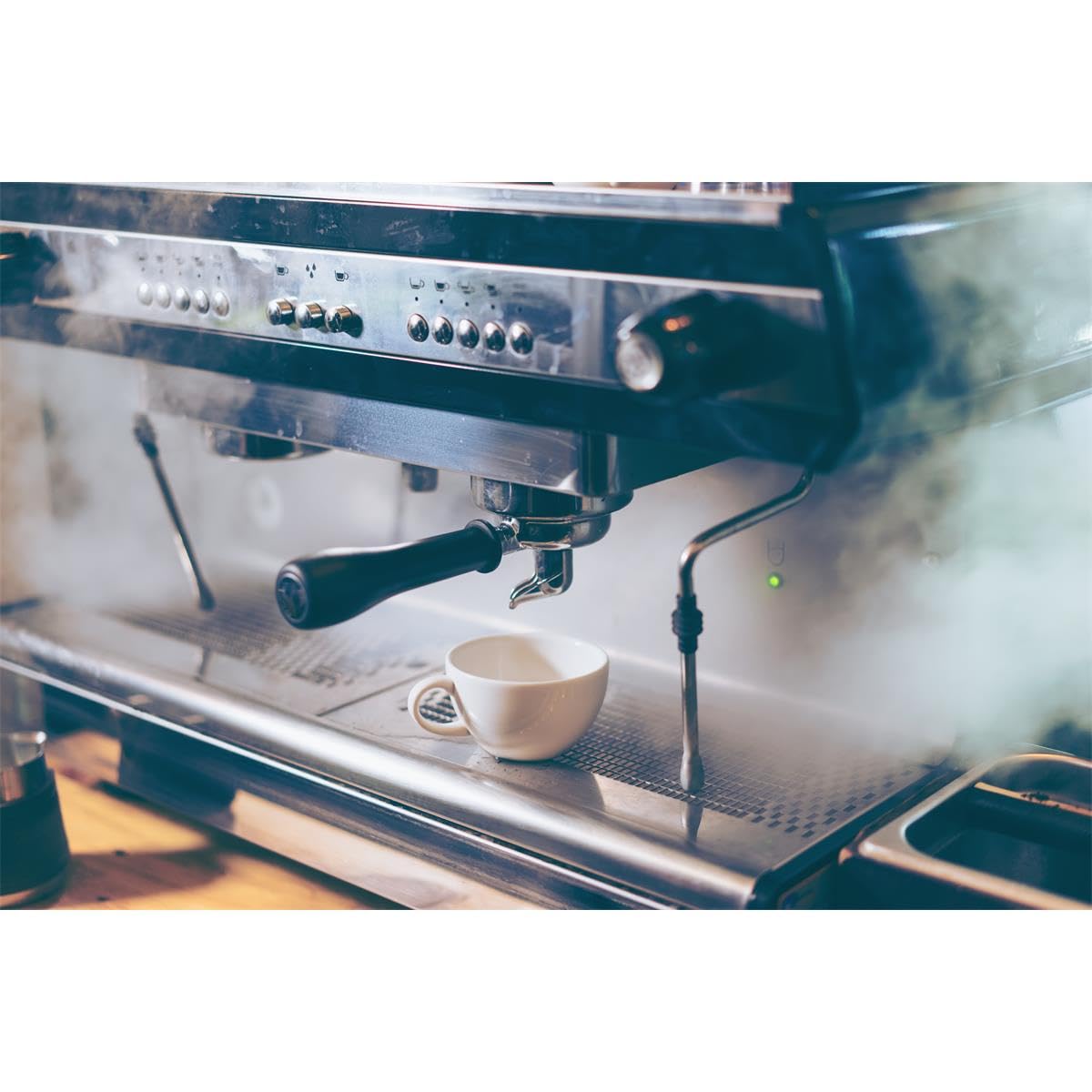 Gaggia decalcifier packaging shown beside espresso machine to encourage routine maintenance.