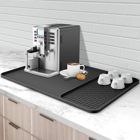 Garolue silicone coffee mat under coffee maker provides heat protection and spill containment.