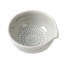 Generic ceramic grater bowl with herb stripper enables quick herb prep and tidy counters.